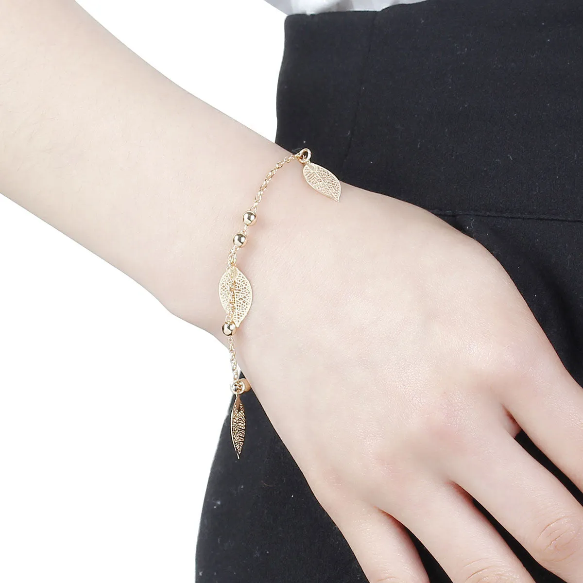 SEXY SPARKLES Filigree Stamping Bell Bracelet  Gold Plated Whit Hollow Leaf Pendants