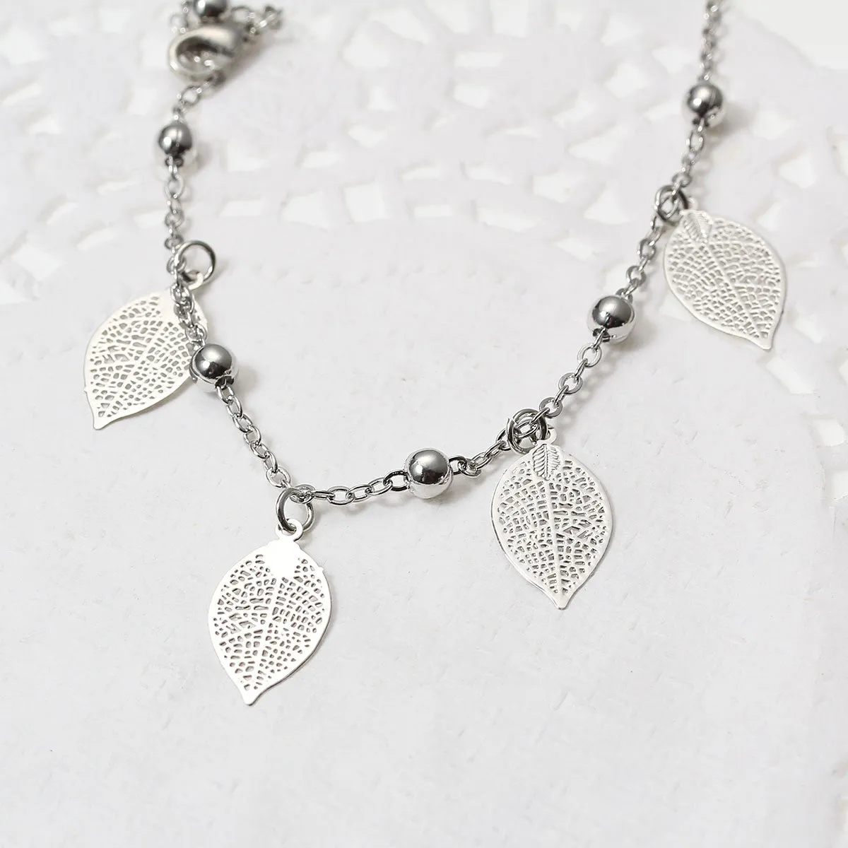 SEXY SPARKLES Filigree Stamping Bell Bracelet Whit Hollow Leaf Pendants